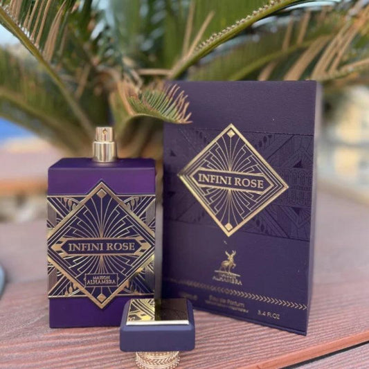 Infini Rose perfume bottle and packaging on a wooden surface with a blurred natural background