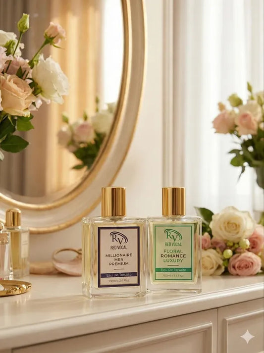 Two perfume bottles on a dresser with flowers and a mirror in the background Buy Red Vocal Millionaire Men & Floral Romance perfume combo 2x100ml. Premium long-lasting EDT for men and women. Ideal gift for couples, 100% original.