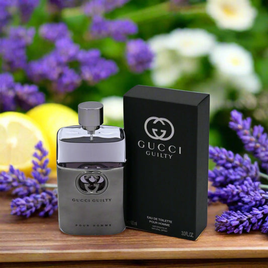 Gucci Guilty perfume bottle and packaging on a wooden surface with flowers in the background Gucci Guilty Pour Homme Eau de Toilette 90 ml (3 fl.oz)