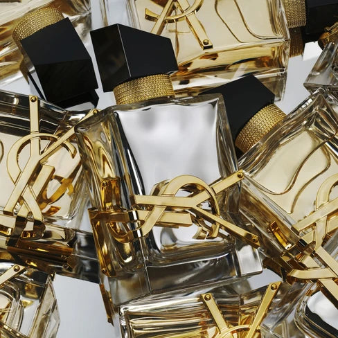YSL perfume bottles with gold caps and clear bodies on a reflective surface Yves Saint Laurent Libre L'Absolu Platine Eau de Parfum 90 ml (3 fl.oz)