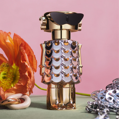 Perfume bottle with decorative cap on a pink background Perfume bottle with decorative cap on a pink background with flowers Paco Rabbane Fame Blooming Pink 80ml