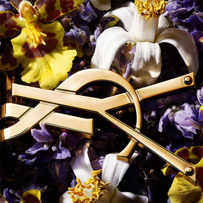 Gold bow-shaped object on a background of colorful flowers Yves Saint Laurent Libre Eau de Parfum Intense 90 ml (3 fl.oz)