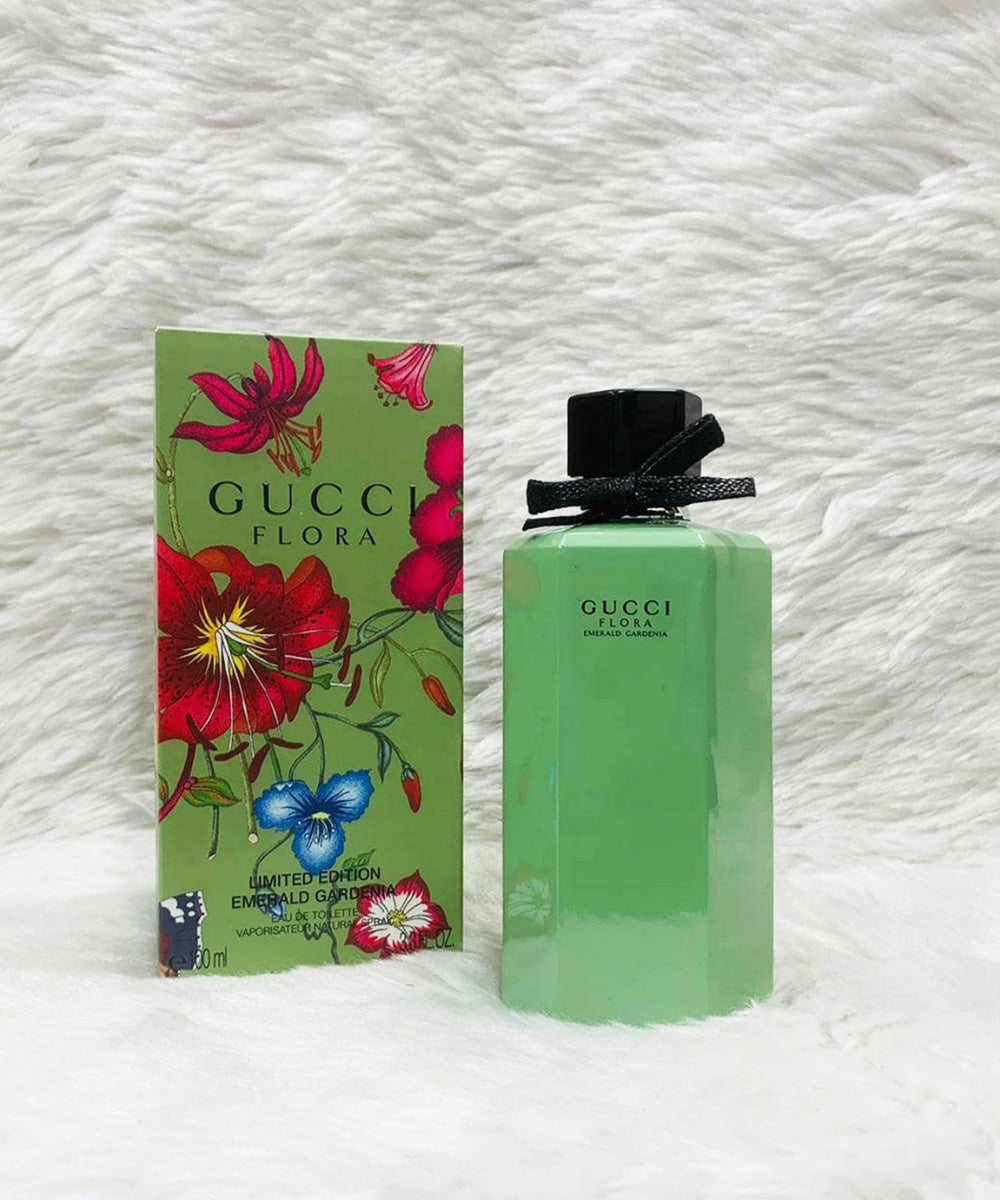 Gucci Flora perfume bottle and packaging on a white textured background Green Gucci perfume bottle and packaging with floral design on a neutral background Gucci Flora Emerald Gardenia 100ml