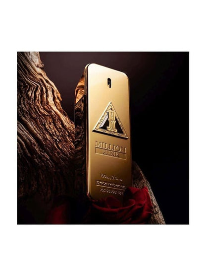 Gold perfume bottle with brand logo on a dark background