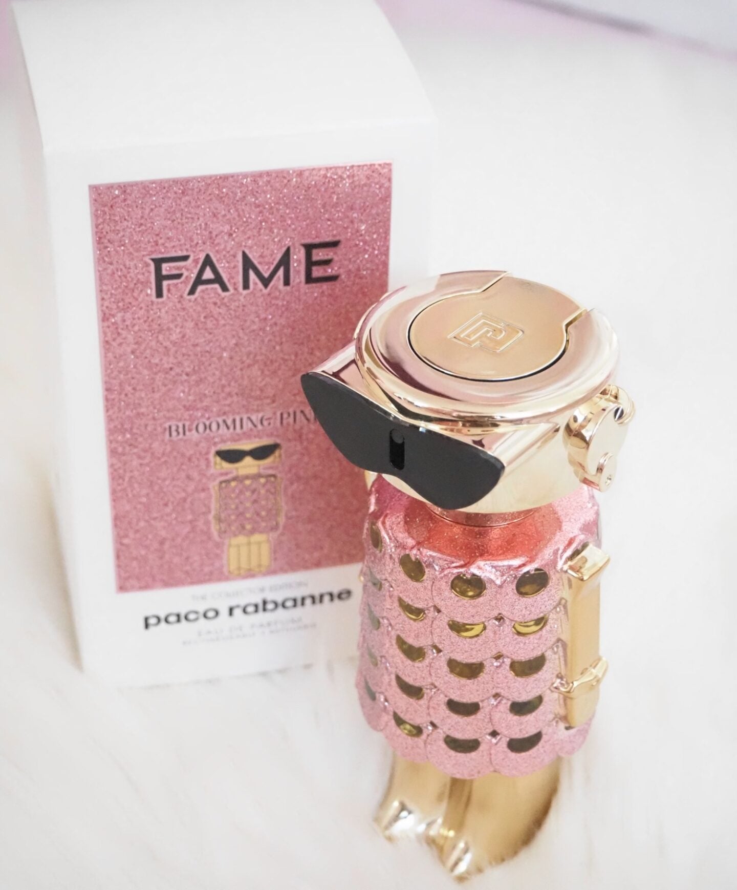 Paco Rabanne perfume bottle with pink packaging and gold accents on a white background
