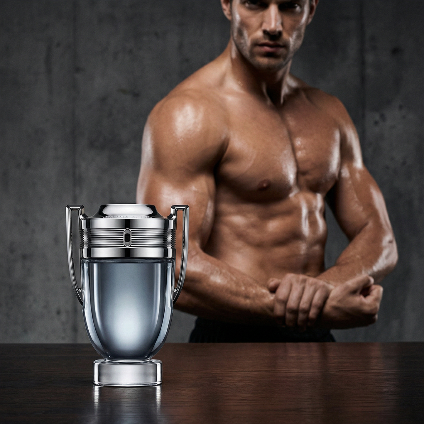 Man with a muscular build standing behind a perfume bottle on a dark surface. Paco Rabbane Invictus Intense 100ml