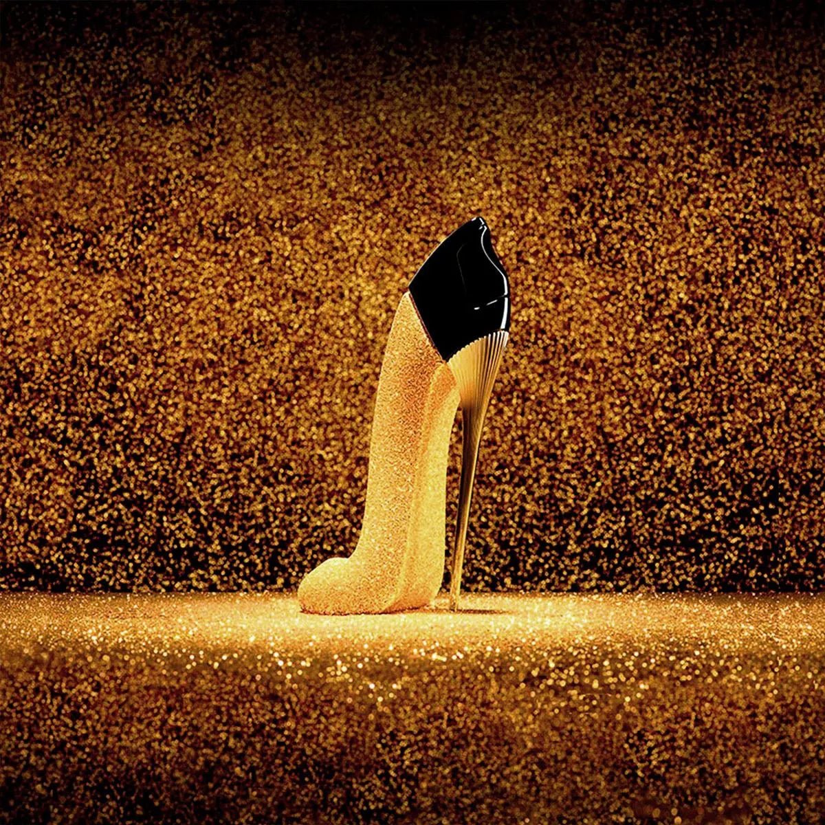 Gold high-heeled shoe on a glittery gold background