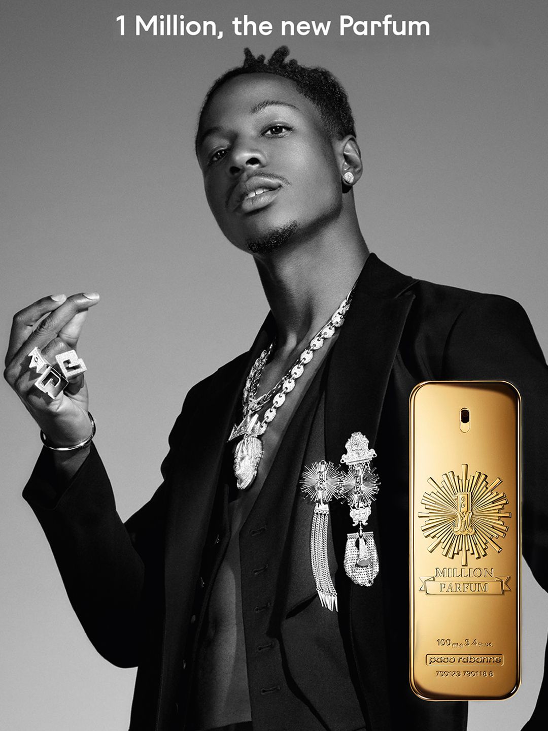 Man holding a gold '1 Million' perfume bottle with text above him.