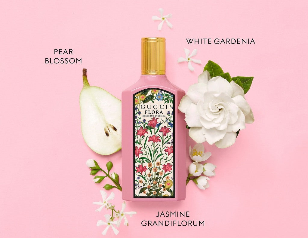 Gucci Flora perfume bottle with floral design on a pink background
