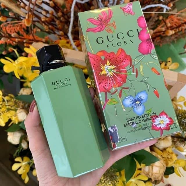 Gucci Flora perfume bottle and packaging held in front of a floral background Green Gucci perfume bottle and packaging with floral design on a neutral background Gucci Flora Emerald Gardenia 100ml