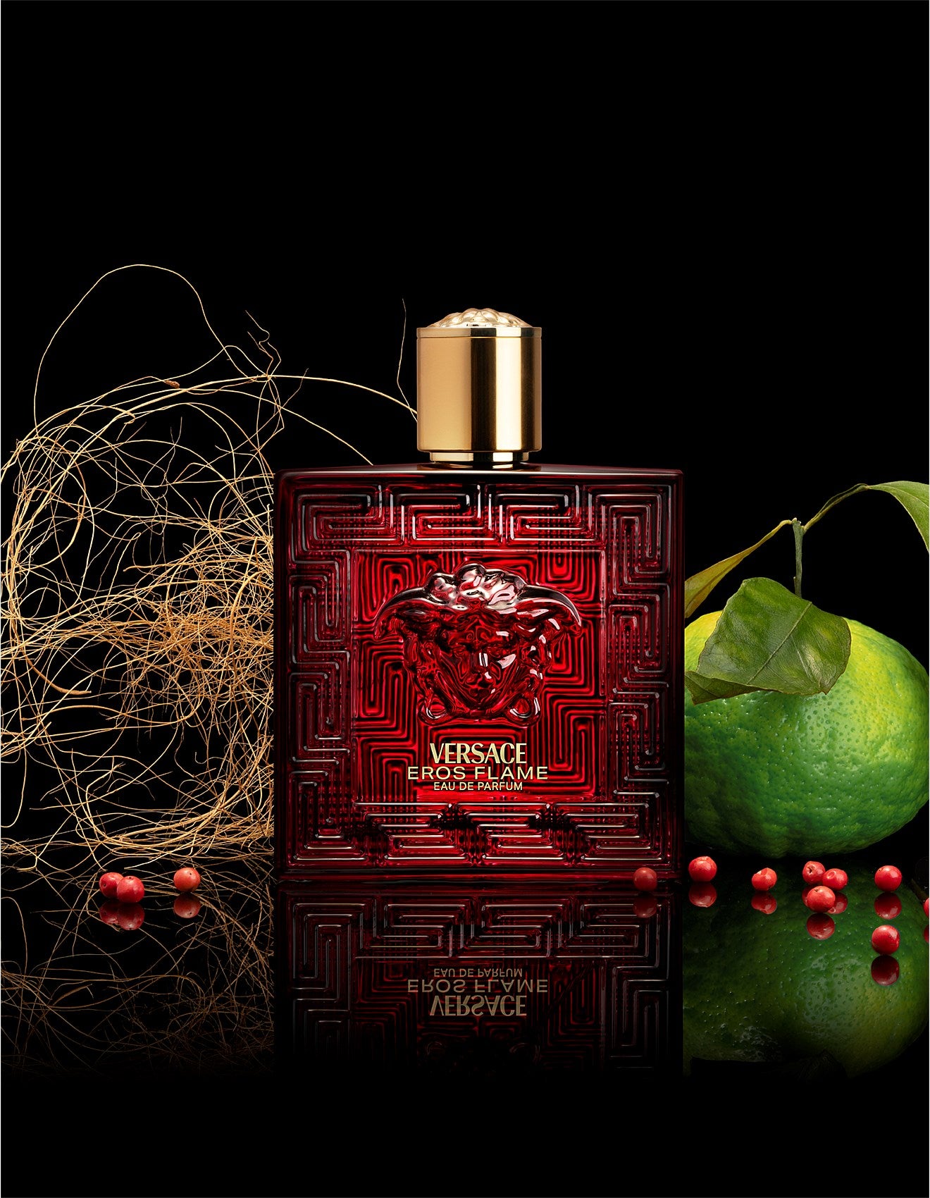 Versace Eros Flame perfume bottle with decorative elements on a dark background