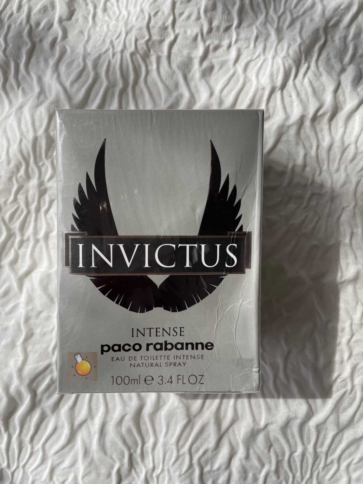 Invictus perfume packaging by Paco Rabanne on a textured white background