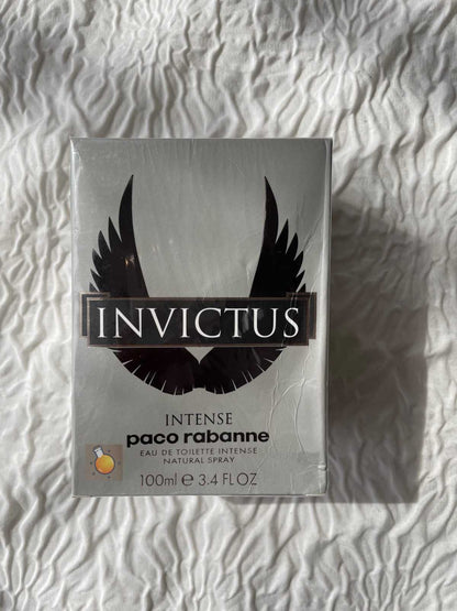 Invictus perfume packaging by Paco Rabanne on a textured white background