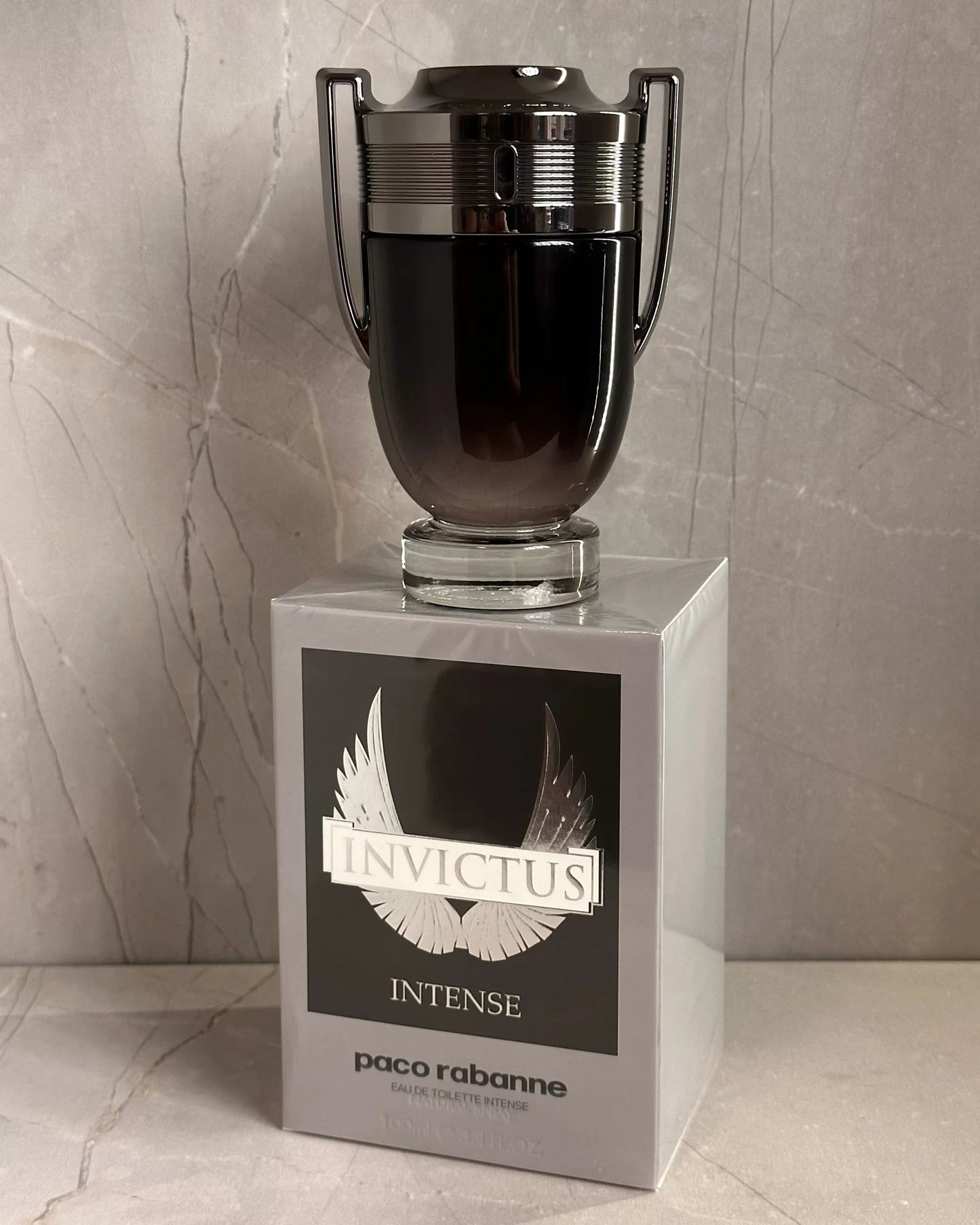 Paco Rabanne Invictus Intense perfume bottle on a marble surface