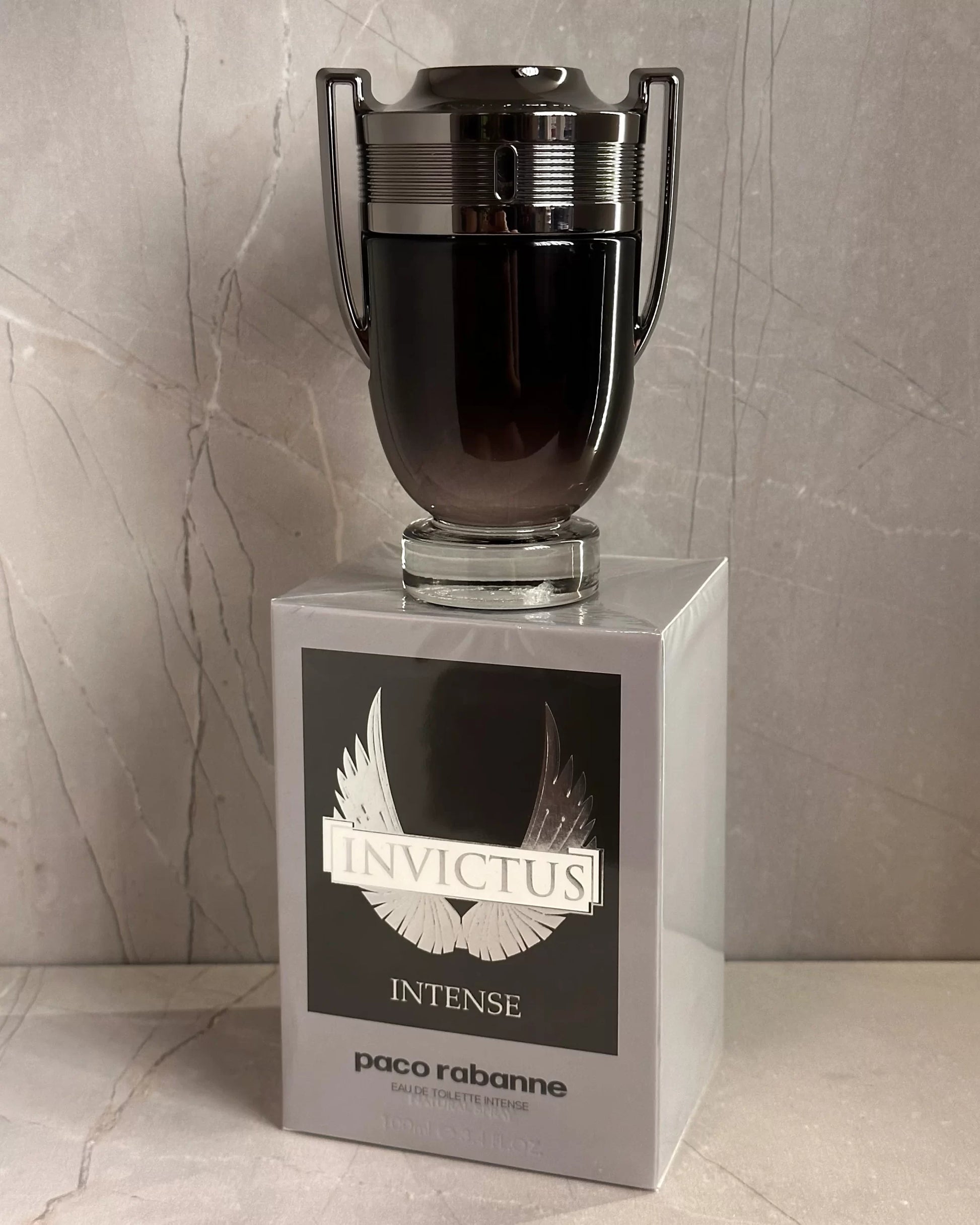 Paco Rabanne Invictus Intense perfume bottle on a marble surface