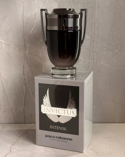 Paco Rabanne Invictus Intense perfume bottle on a marble surface