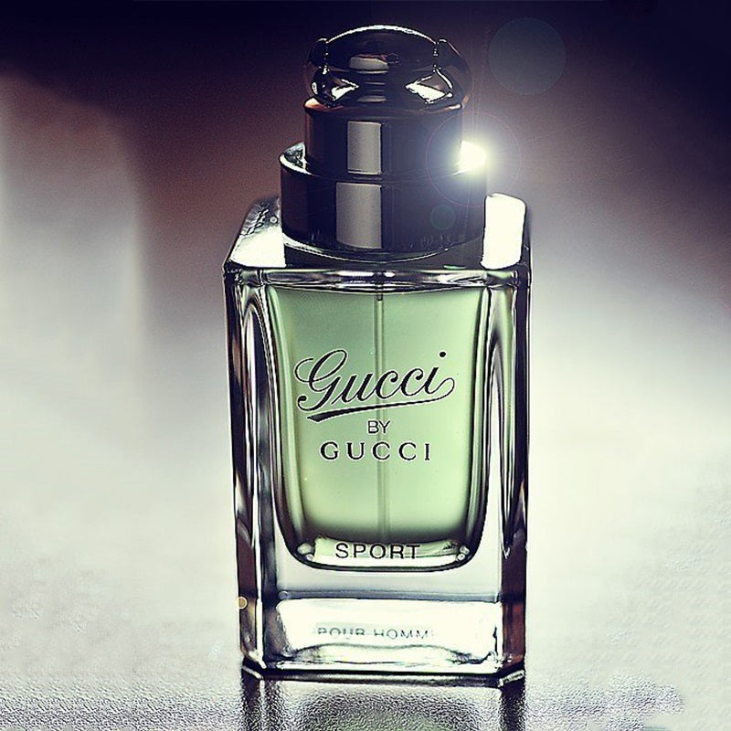 Gucci Sport perfume bottle on a reflective surface with a dark background Gucci by Gucci Sport Pour Homme Eau de Toilette 90 ml (3 fl.oz)