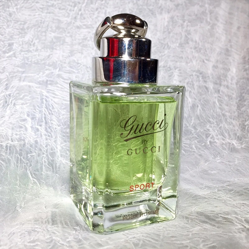 Gucci Sport perfume bottle on a textured gray background Gucci by Gucci Sport Pour Homme Eau de Toilette 90 ml (3 fl.oz)