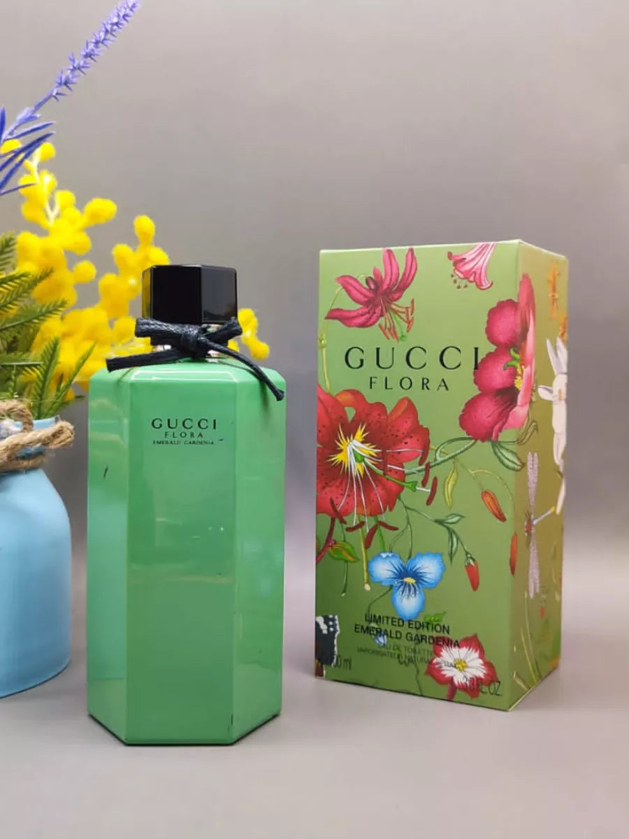 Green Gucci perfume bottle and packaging with floral design on a neutral background Gucci Flora Emerald Gardenia 100ml