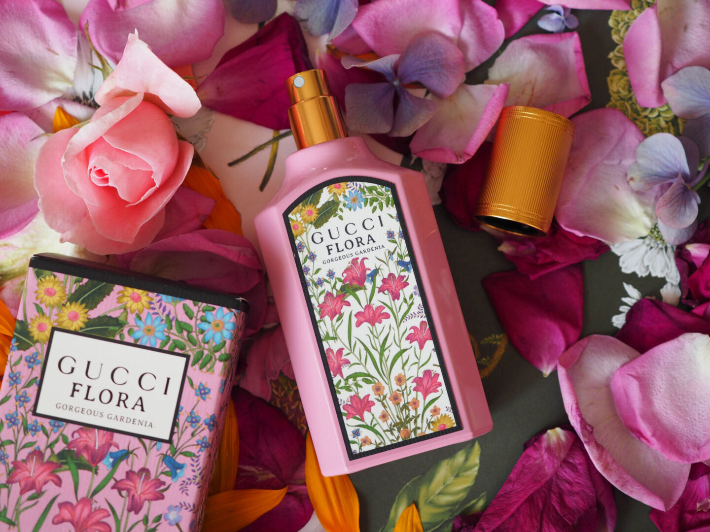 Gucci Flora perfume bottles surrounded by flowers