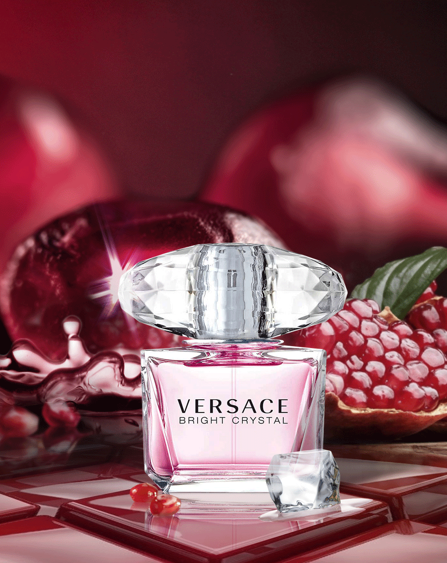 Versace Bright Crystal perfume bottle with pomegranate fruits on a red background