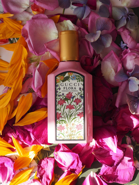 Gucci Flora bottle surrounded by colorful flowers and petals