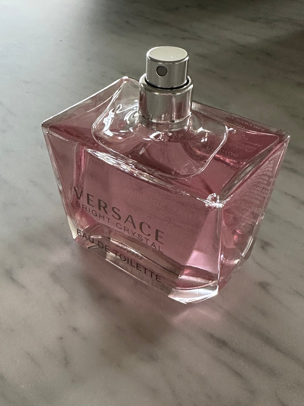 Versace Eau de Toilette bottle on a marble surface