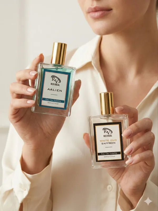 Person holding two Revuele perfume bottles labeled 'Alien' and 'Saffron' against a neutral background. Red Vocal Aalien & White Oud Saffron Premium Perfume Set | Unisex Eau De Toilette | 2 x 50ml 