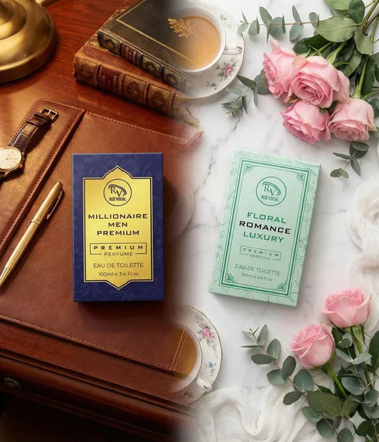 Two perfume boxes on a marble surface with flowers and a watch. Buy Red Vocal Millionaire Men &amp; Floral Romance perfume combo 2x100ml. Premium long-lasting EDT for men and women. Ideal gift for couples, 100% original.