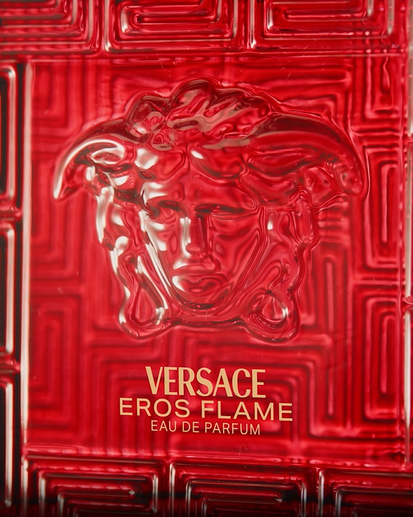 Red Versace Eros Flame perfume bottle on a black background