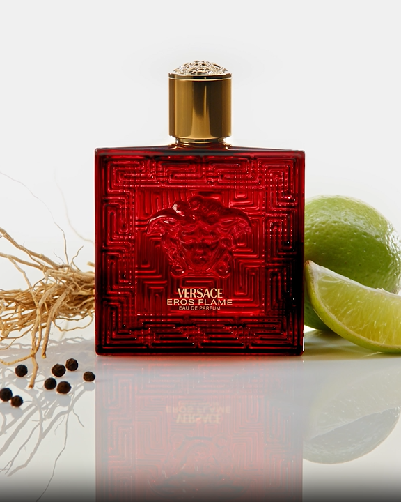 Red perfume bottle with gold cap on a white background