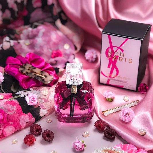 YSL Mon Paris perfume bottle and packaging on a decorative background with flowers and berries. Yves Saint Laurent Mon Paris Intensement Eau de Parfum 90 ml (3 fl.oz)