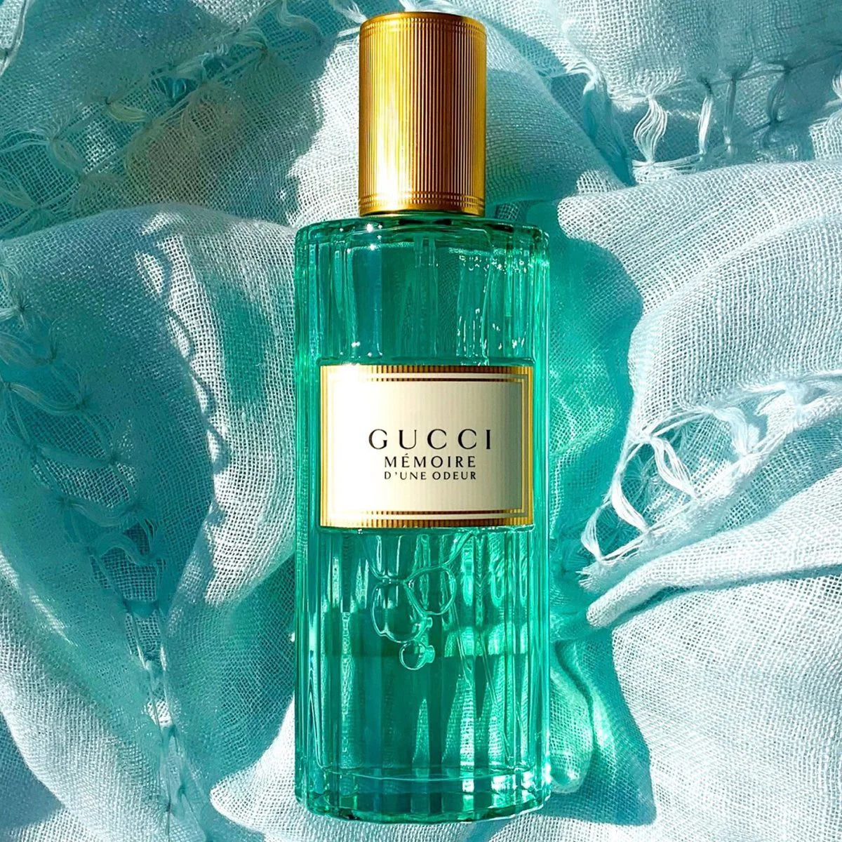 Green Gucci perfume bottle on a textured light blue background Gucci Mémoire d'une Odeur Eau de Parfum 100 ml (3.4 fl.oz)